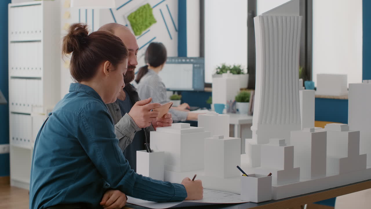 Architects collaborating on building design using model