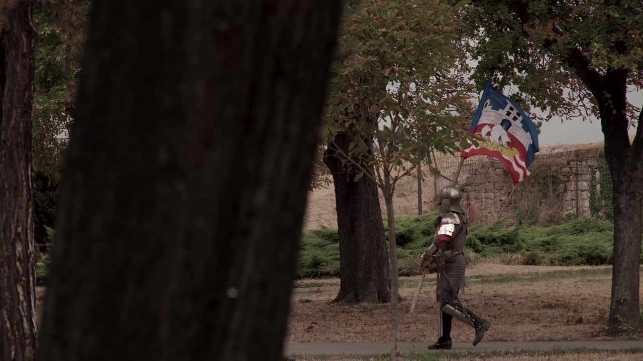 Knight carrying flag through ruins at Belgrade Fortress, Serbia