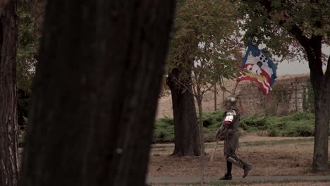 knight carrying flag through ruins at belgrade fortress, serbia