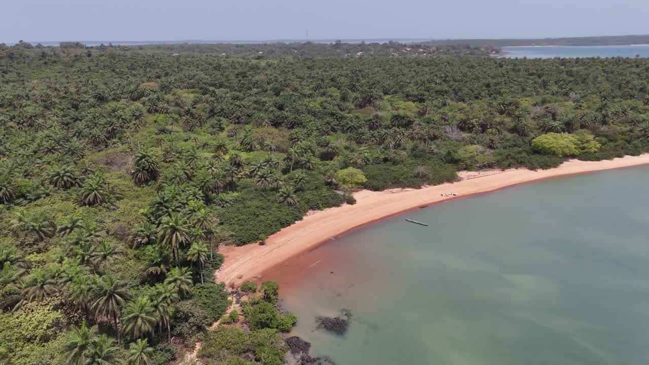 Scenic drone footage of tropical Pink Sand Beach in West Africa, showing pristine coastlines and crystal-clear ocean waves