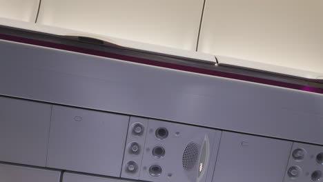 interior view of an aircraft cabin ceiling featuring air vents and overhead compartments, with a focus on inflight amenities