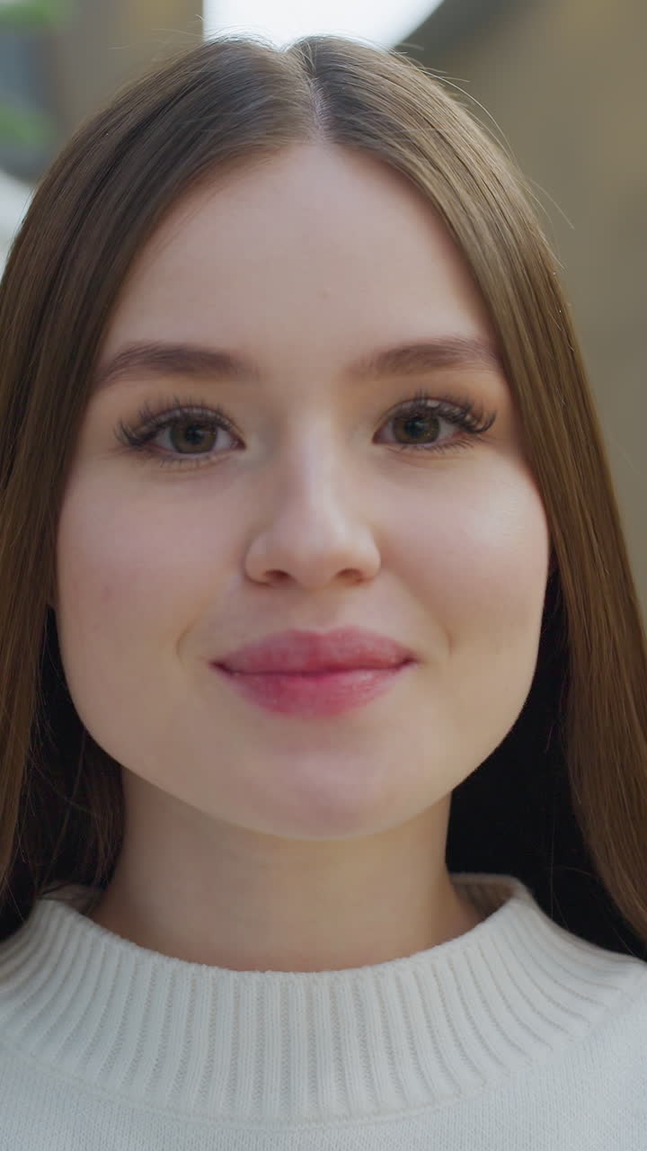 Elegant woman smiling warmly near Santa Claus figure with beautifully decorated Christmas tree in background, creating a joyful, festive atmosphere filled with holiday spirit and cheer
