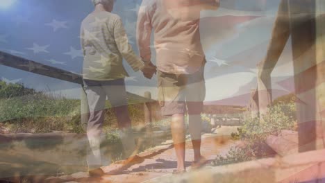 animation of senior caucasian couple holding hands on beach over flag of united states of america