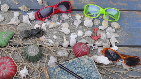 sea shells on a blue background. summer traveling time. sea holiday background with various shells, sunglasses and vintage camera. lay design. top view. flat lay