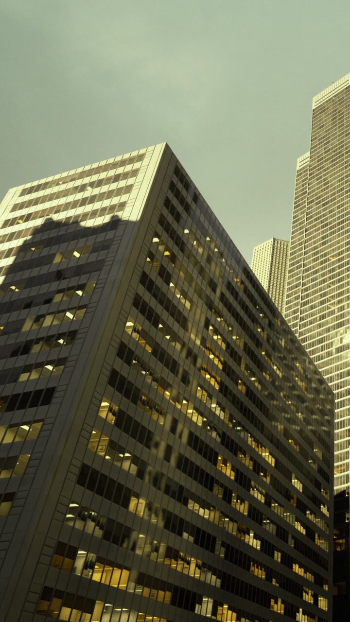 Modern skyscrapers cast shadows in a bustling urban landscape during twilight