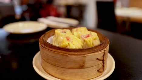 hot dumplings served in a bamboo steamer