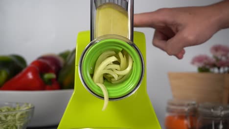 cutting a whole potato in an automatic grater in slowmotion