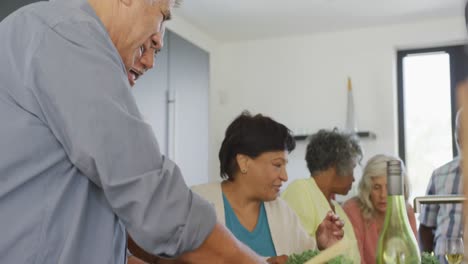 Happy-senior-diverse-people-cooking-in-kitchen-at-retirement-home