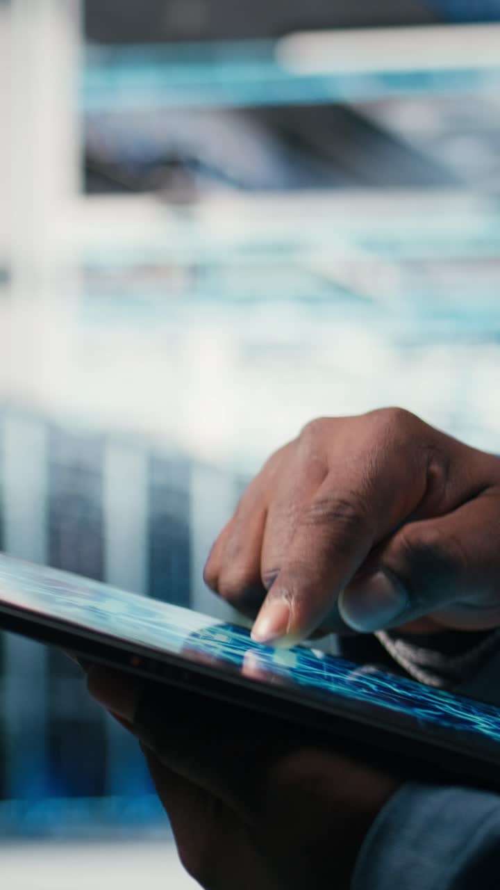 Vertical video Close up of data center engineer using AI software on tablet