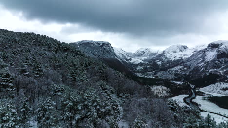 Backwards-drone-hyperlapse---cinematic-reveal-of-snow-covered-alpine-valley