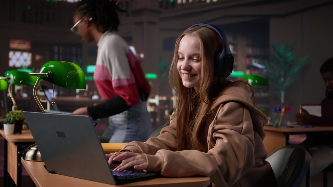 Vertical video girl studying in the library to obtain her diploma with focus music on headset