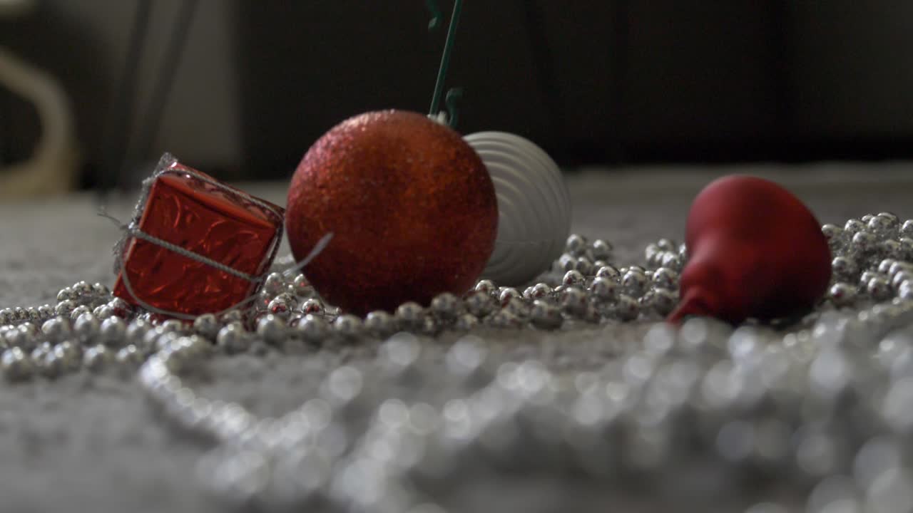 red bauble dropping on the floor