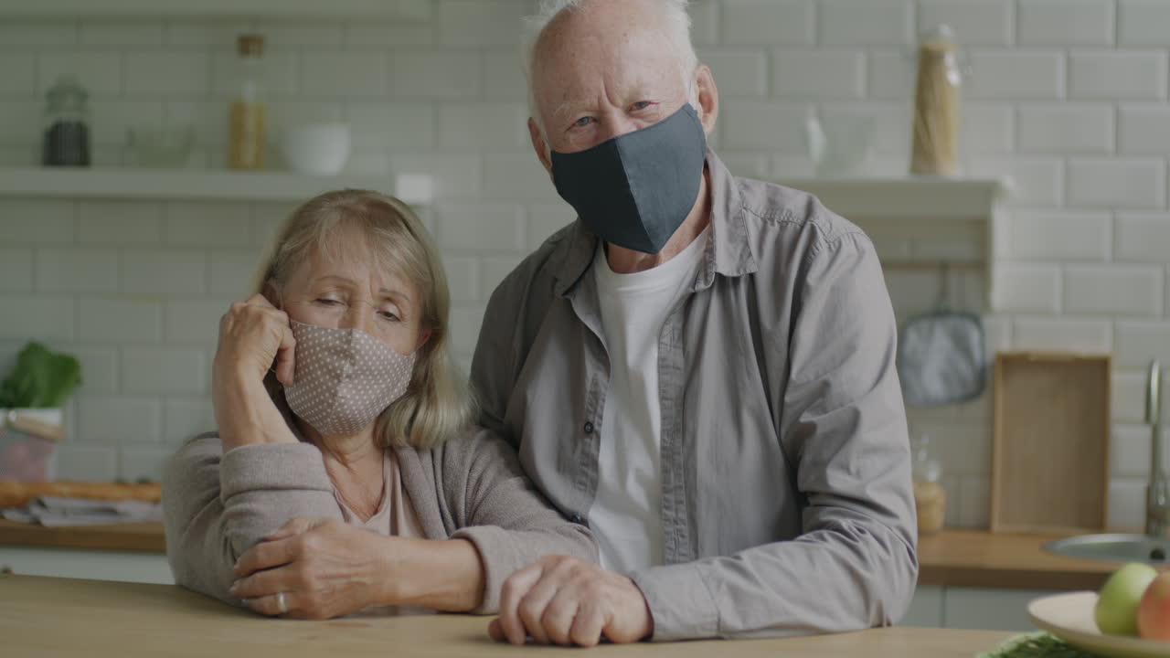 Elderly Couple Wearing Masks in Kitchen
