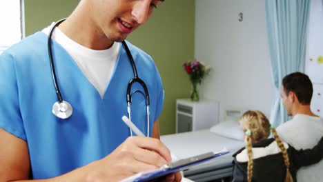 Doctor-writing-medical-report-in-hospital