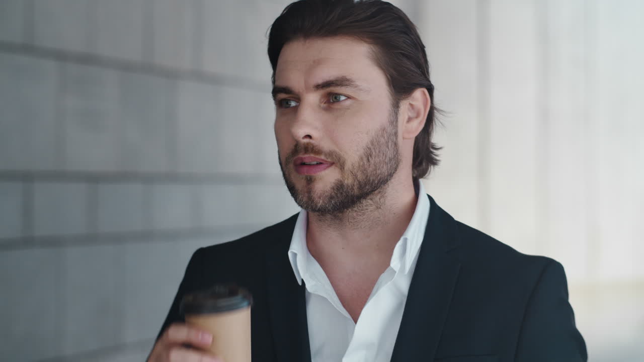 Businessman drinking coffee on street. Male manager checking time on wristwatch