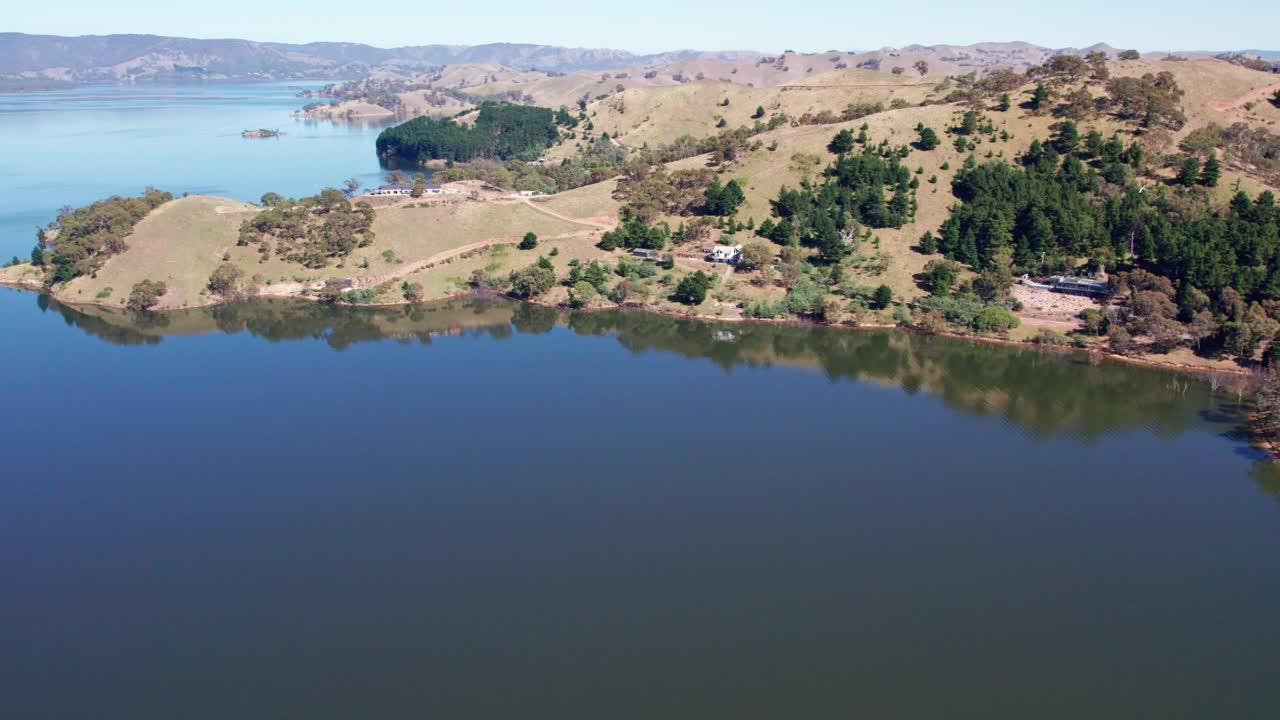 Aerial footage of the landscape at Lake Eildon in the sun, near Mansfield in central Victoria, Australia. The storage was 97% full. February 2024.