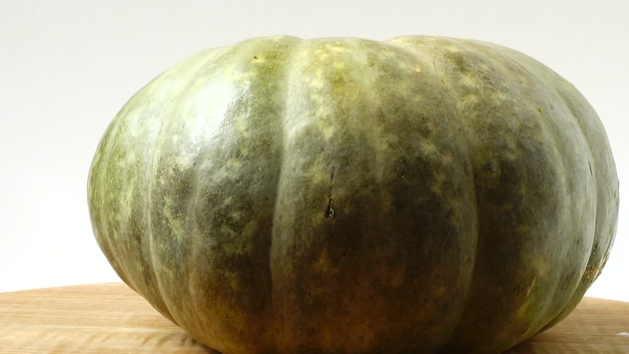 Pumpkin on a kitchen board. Shooting in the movement