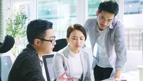 asian businessmen and woman working together in office