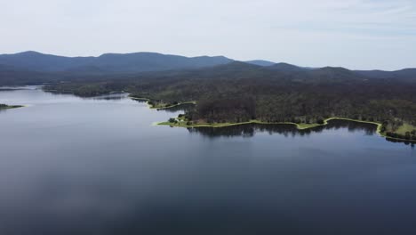 Aerial-view-of-a-beautiful-lake-with-green-algae-all-around-the-edges-of-the-lake