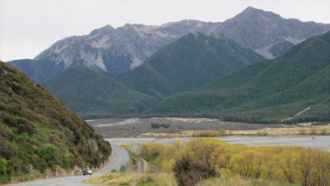 black 4wd driving along the state highway through arthurs pass, new zealand