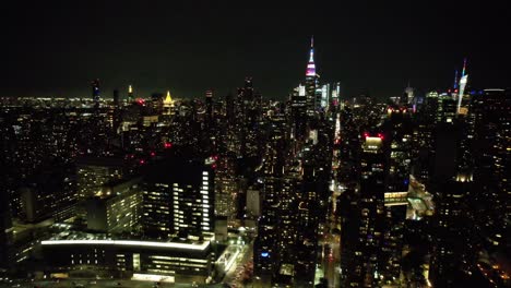 a high angle, aerial view of manhattan from over the east river in ny