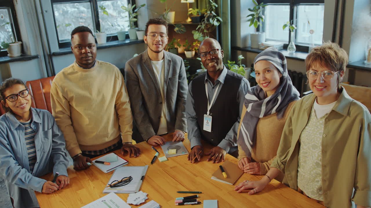 Group Portrait of Happy Immigrant Students and Teacher in Language School
