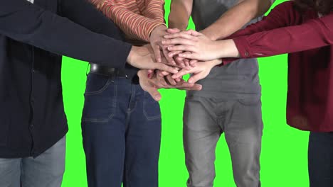 close up of young people joining their hands