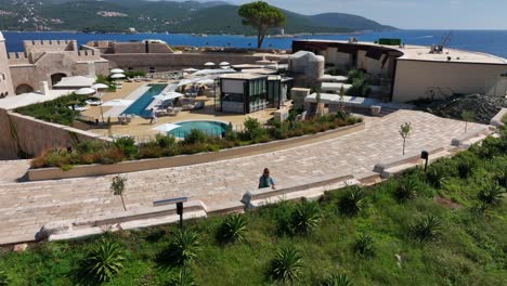 aerial zoom-out of mamula island resort surrounded by clear sea and sunshine