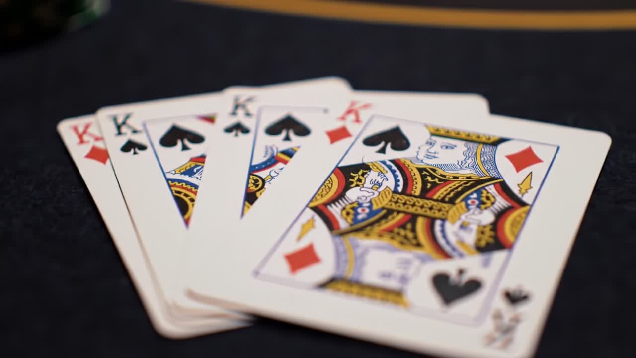 A Close-Up of Cards: An Intense Poker Showdown Featuring Kings and Aces on a Felt Table with Intricate Design and Engaging Bidding Dynamics