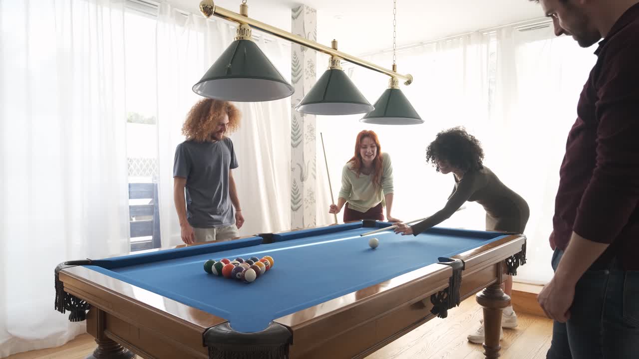 Group of diverse friends playing pool game