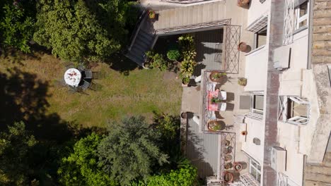 aerial spiraling shot revealing a large villa with a small balcony in france