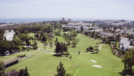 aerial fly over of a luxurious golf course in marbella, spain