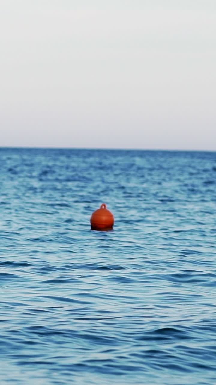Buoy in the open sea. Lonely buoy in beautiful blue sea