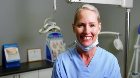 dental assistant standing with arm crossed in clinic