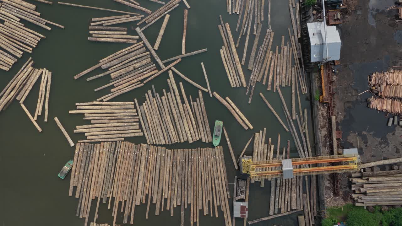 Aerial view of a sawmill sorting and processing wooden logs in water