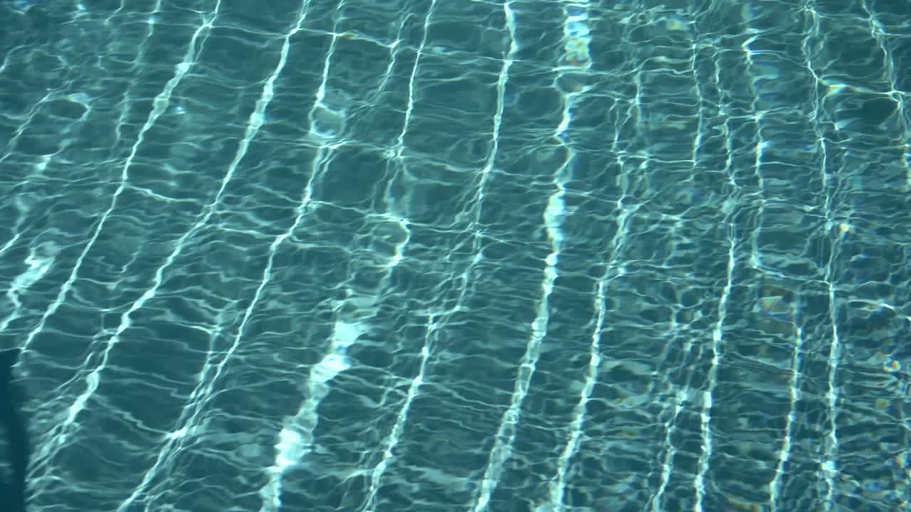 Water surface texture, Slow motion looping clean swimming pool ripples and wave, Refraction of sunlight top view texture sea side white sand, sun shine water loop background,