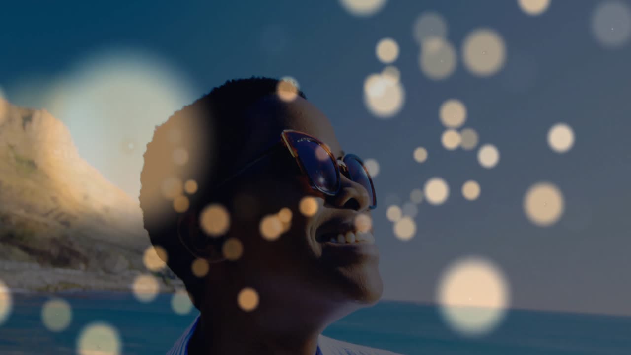 Woman tilting head following golden bokeh over ocean horizon, illustrating health meditation