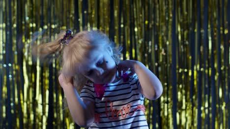 Portrait-of-trendy-stylish-teen-girl-listening-to-music,-dancing,-shaking-head-at-disco-party-club