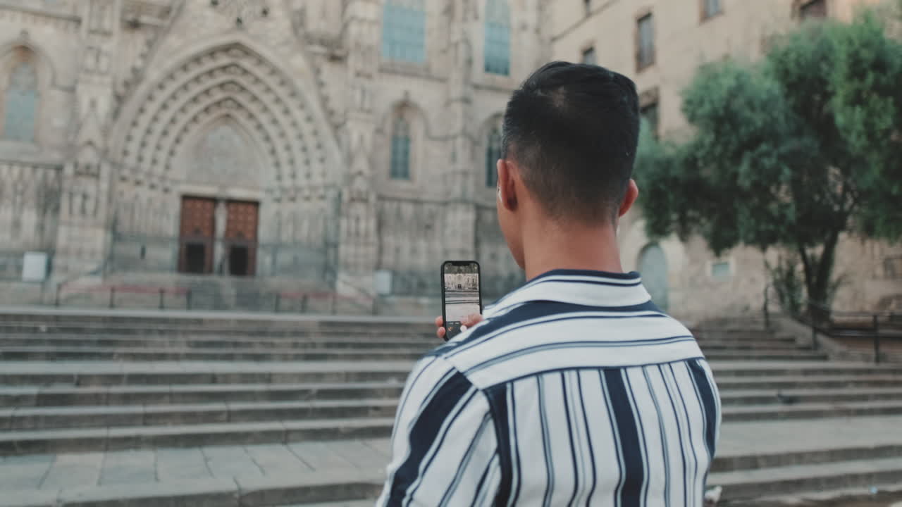 Man taking a photo of a cathedral