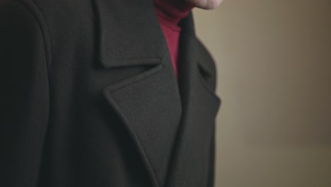 man wearing a neat charcoal gray double-breasted wide notch lapel overcoat - closeup shot