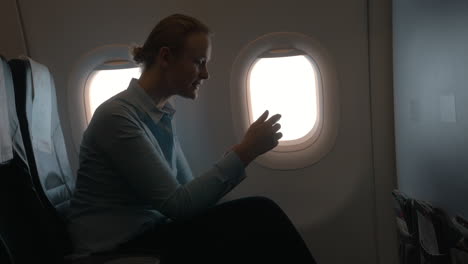 madre e hijo en el avión pagando con un lector de tarjetas móvil