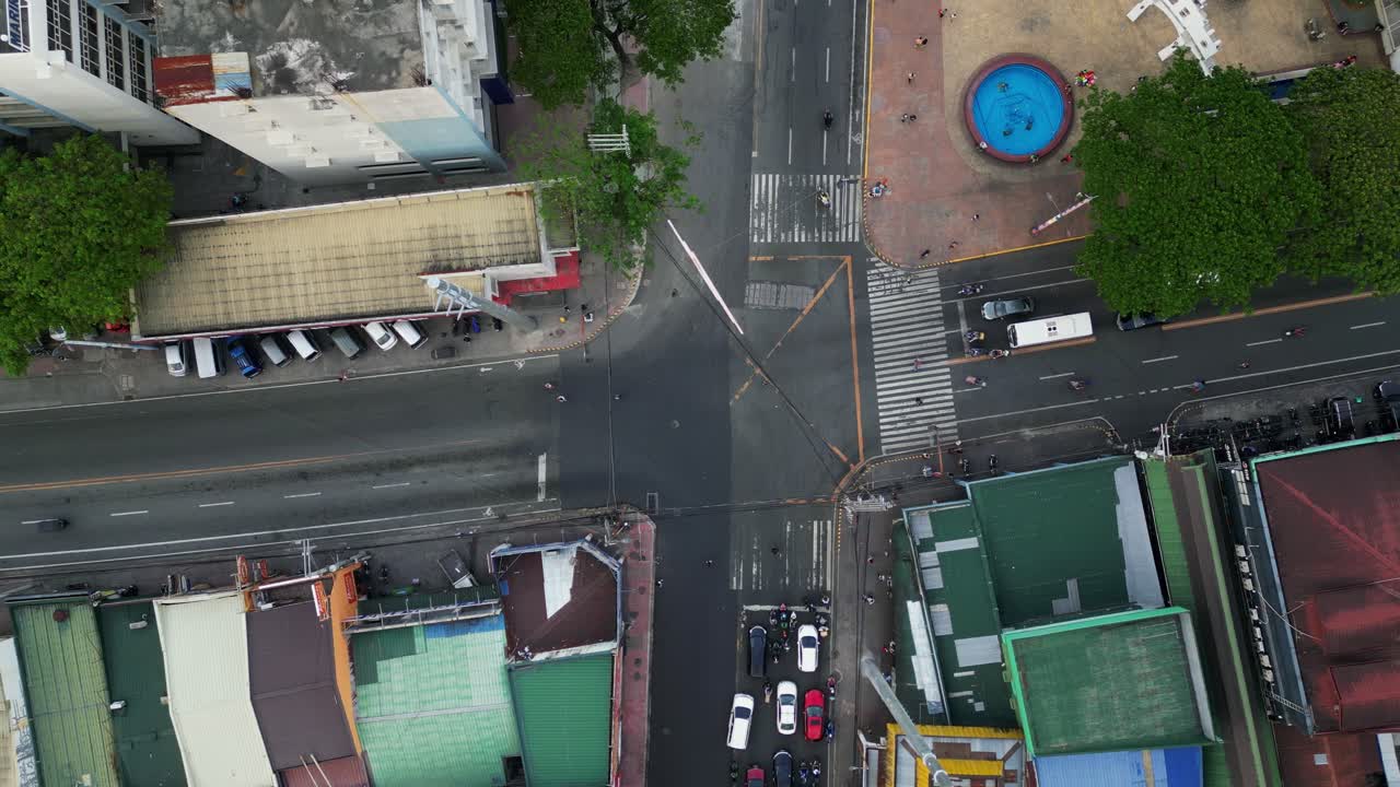 Aerial top-down view of four-way intersection traffic along Shoe Avenue at Marikina City, Philippines