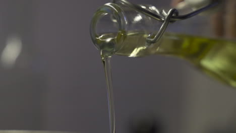 close shot of a bottle, as pouring olive, or sunflower oil