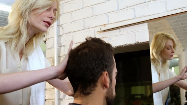 Man getting his hair trimmed with scissor