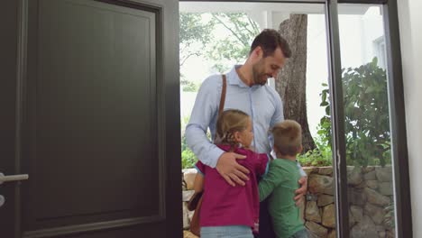 father embracing his children at door in a comfortable home 4k