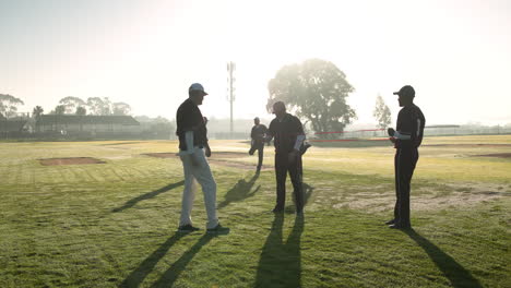 Baseball players warming up with resistance bands during morning practice on field
