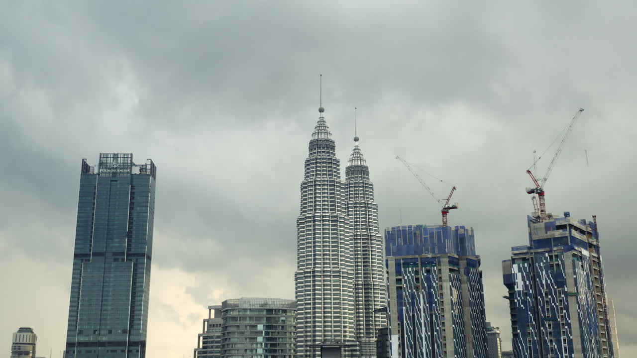 Petronas Twin Towers,construction cranes,Kuala Lumpur,Malaysia,cloudy