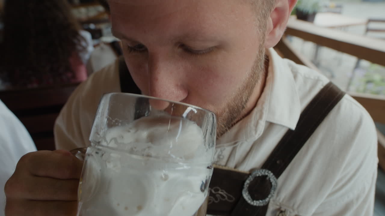 Man in traditional clothing drinking beer