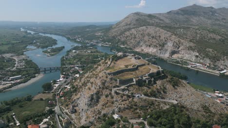 rozafa castle perched on a hilltop with scenic river views and surrounding mountains on a sunny day