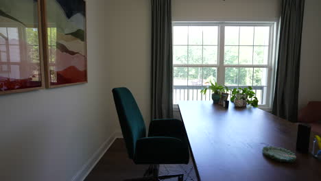 minimalist home office design seen from a side slider shot with plant in the foreground, work from home concept